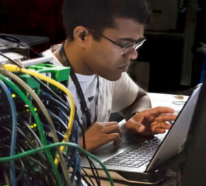 Recent NIU graduate Bhaskar Mandapaka works on an 80-watts supercomputer that will be used as an outreach tool for the ALCF. (Credit: Chloe Insley, ALCF Summer Intern, Southern Illinois University)