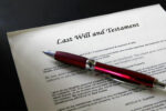 Photo of a pen and a "Last Will and Testament" form