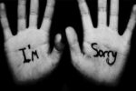 Photo of “I’m Sorry” written on palms