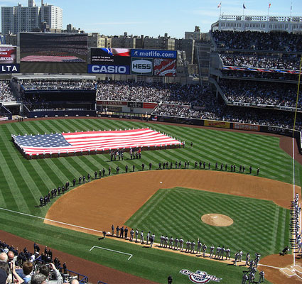Photo of a flag on a baseball field during the national anthem