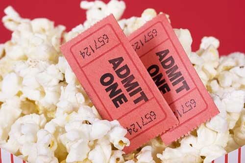 Photo of popcorn and movie tickets