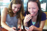 Teens texting and giggling