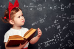 Photo of a kindergarten girl and a chalkboard covered in algebra