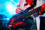 Photo of a man playing an electric guitar